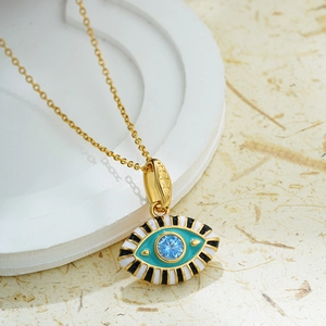 Detail of 18K gold plated evil eye pendant necklace with blue enamel and colorful zircon