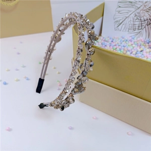 Detail of double-layer crystal headband with faceted beads and golden floral accents