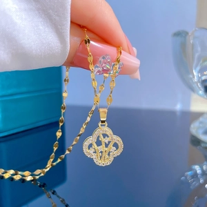 Close-up of gold-plated titanium steel clover necklace with pavé micro-zirconia stones