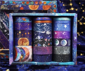Close-up of starry sky themed washi tape set in a premium blue galaxy gift box