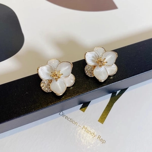 Detail of floral earrings with pearl petals and sparkling micro-inlaid diamonds