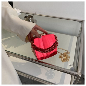 Detailed view of red mirror finish box bag with resin chain and metallic strap