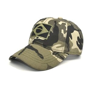 Detailed macro view of the camouflage pattern fabric and Brazilian flag embroidery on the cap