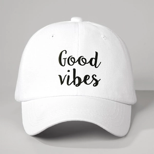 Close-up of white baseball cap with black Good Vibes embroidery and breathable eyelets