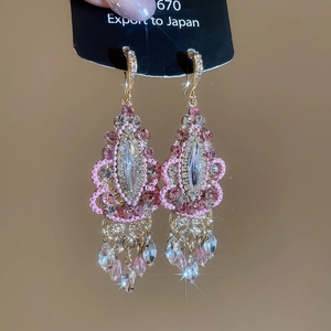 Detailed close-up of water drop tassel earrings with sparkling pink and clear crystals
