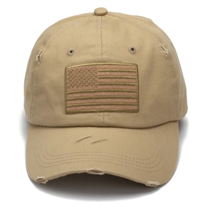 Detail of distressed khaki baseball cap with American flag patch and worn-out effects