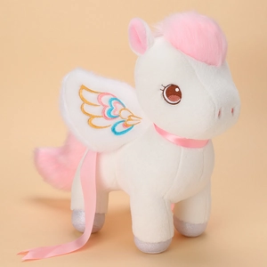 White unicorn plush toy with pink mane and rainbow wings on light beige background