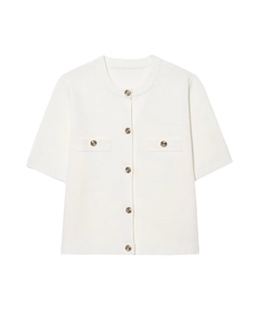 Detail of white short sleeve knit cardigan with golden buttons and textured pockets