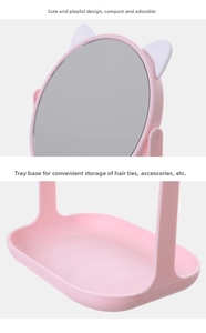 Detail of pink cat-ear vanity mirror with a round HD lens and jewelry storage tray