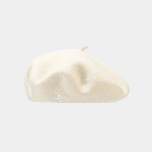 Detailed texture of off-white wool beret with minimalist white symbol embroidery