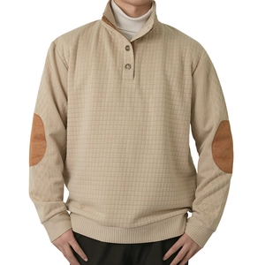 Detail of khaki waffle knit texture with contrast elbow patches and button half-collar