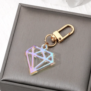 Iridescent acrylic diamond keychain with gold metal hook on a jewelry display box
