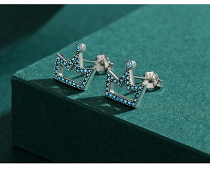 Macro view of S925 crown studs with turquoise stones and clear hallmark detail