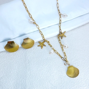 Detail shot of gold shell and starfish jewelry set with pearls and rhinestones