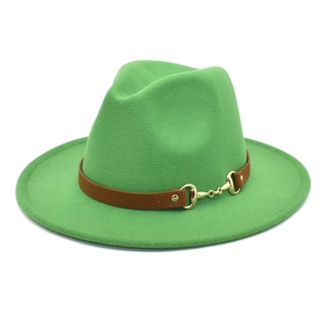 Close-up of grass green wool fedora hat with brown leather band and golden horsebit