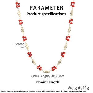 Detail of red enamel butterfly pendant on gold-plated copper chain necklace with gold beads