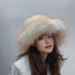 Detailed view of long white faux fur bucket hat with brown tips on studio background