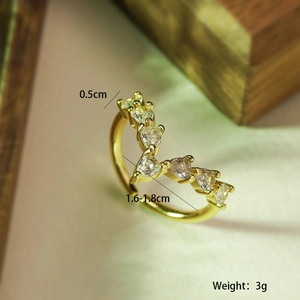 Macro shot of V-shaped gold plated ring with zircons showing dimensions and weight details