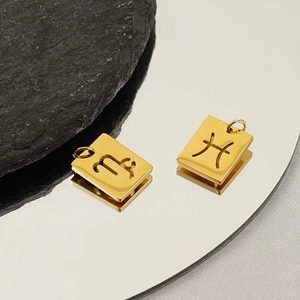 Gold square zodiac pendants in 18K stainless steel shown on a reflective surface
