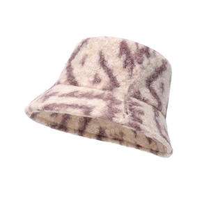Detailed close-up of thick beige plush bucket hat showing curly faux fur texture and pattern