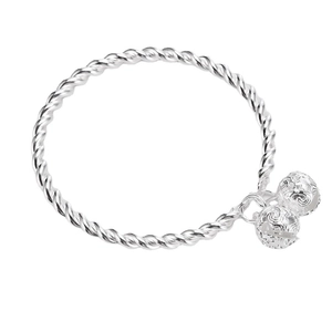 Silver twisted cable bangle with dual hollow bell charms on a clean white background