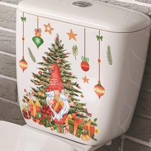 Christmas gnome and tree self-adhesive decals applied on a white ceramic toilet tank