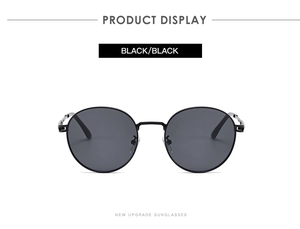 Front view detail of retro round black metal sunglasses with dark polarized lenses