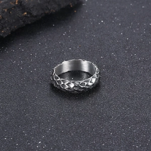 Macro shot of silver stainless steel ring featuring detailed 3D snake scale textures