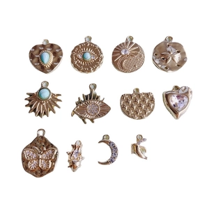 Set of 11 gold-plated alloy charms featuring evil eye, moon, and heart with zircon inlays