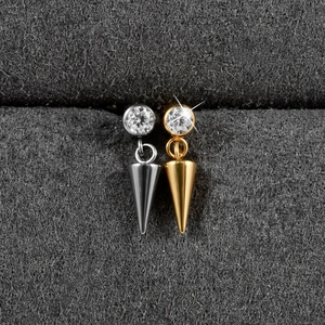 Macro view of gold and silver G23 titanium sword pendants with sparkling zircon stones