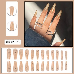 Long ballet press-on nails with golden glitter sequins and beige nude gloss finish