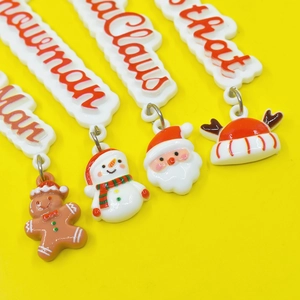 Detailed view of Christmas resin charms featuring Santa Claus, Snowman and Gingerbread Man