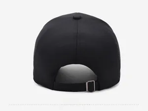 Rear view of black cotton baseball cap showing adjustable fabric strap and bronze buckle