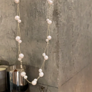 Detailed close-up showing the irregular pearl arrangement and delicate multi-strand design