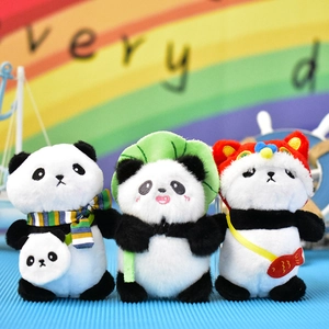 Detailed view of three panda plush charms with scarf, leaf hat, and festive lion dance outfit.