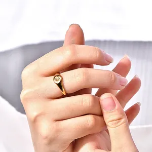 Gold stainless steel signet ring featuring a polished starburst engraving for unisex punk style