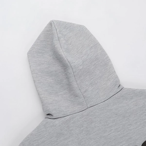 Close-up of gray fleece hoodie showing the hood cut and soft knit fabric texture