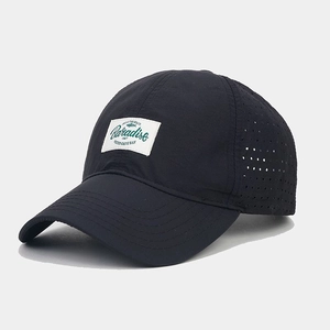 Detail of breathable laser-cut holes and Paradise label on quick-dry baseball cap