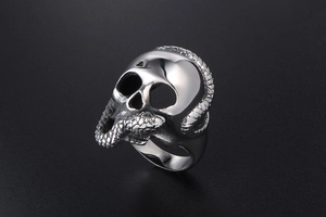 Close-up of gothic stainless steel ring with skull and snake design in silver finish