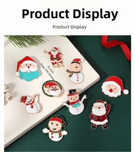 Close-up of colorful Christmas brooch pins with Santa and snowman on pine branches