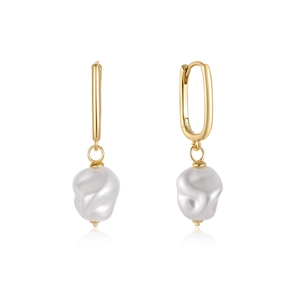 Detailed view of elegant gold U-shaped earrings with hanging white baroque pearls