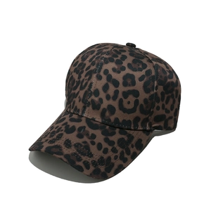 Detailed close-up of a leopard print baseball cap with a pre-curved brim on a white background