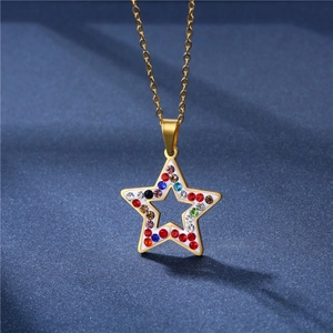 Golden star pendant necklace with colorful crystals on a textured blue background