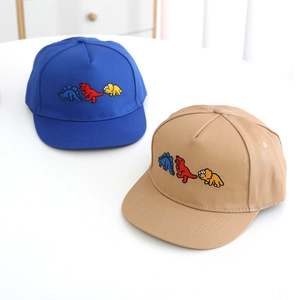 Close-up of three colorful dinosaur embroidery on cotton kids baseball hats