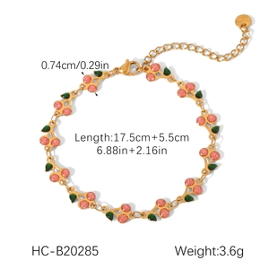 Close-up of 18K gold-plated stainless steel cherry bracelet showing pink glitter charms