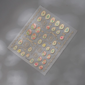 Detailed close-up of gold-stamped tulip nail stickers with elegant floral patterns