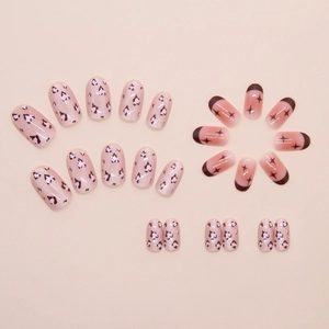 Detail of pink cat eye nails with leopard print and nude French tip star design