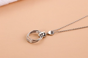 Macro shot of interlocking circles necklace with a polished silver stainless steel finish