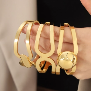 Minimalist gold plated stainless steel hollow geometric bangle set with spherical detail
