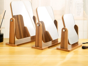 Three sizes of rotating wooden desk mirrors with brown wood grain on light tabletop